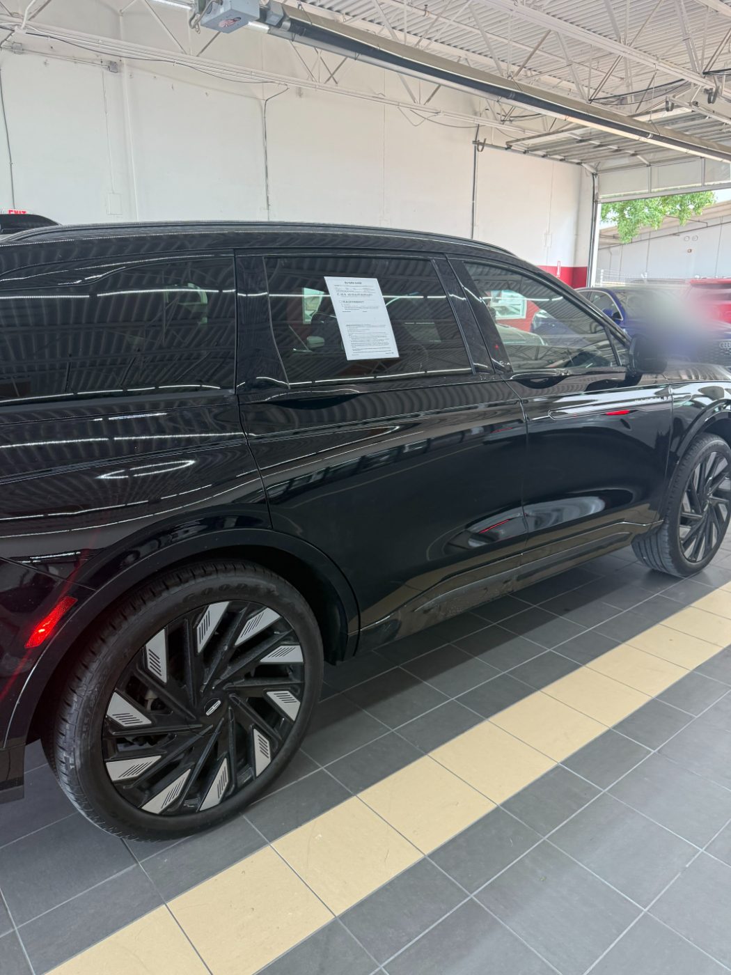 Lincoln Nautilus after collision repair, glossy black panels and even gaps on the showroom floor