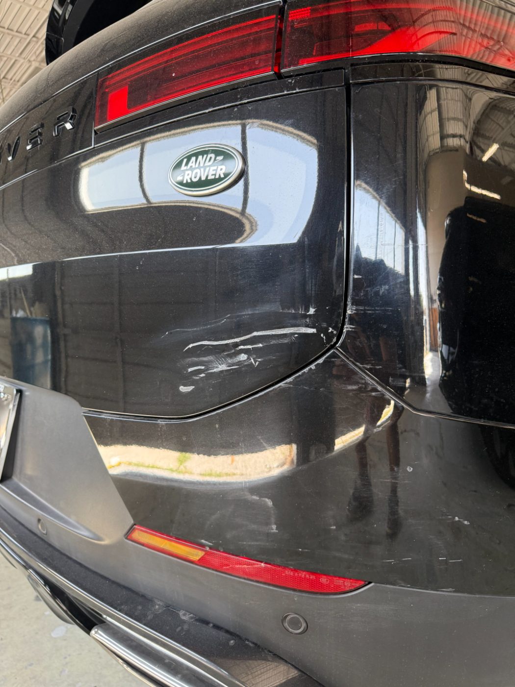 Range Rover rear quarter with a deep scrape across the tailgate before refinishing