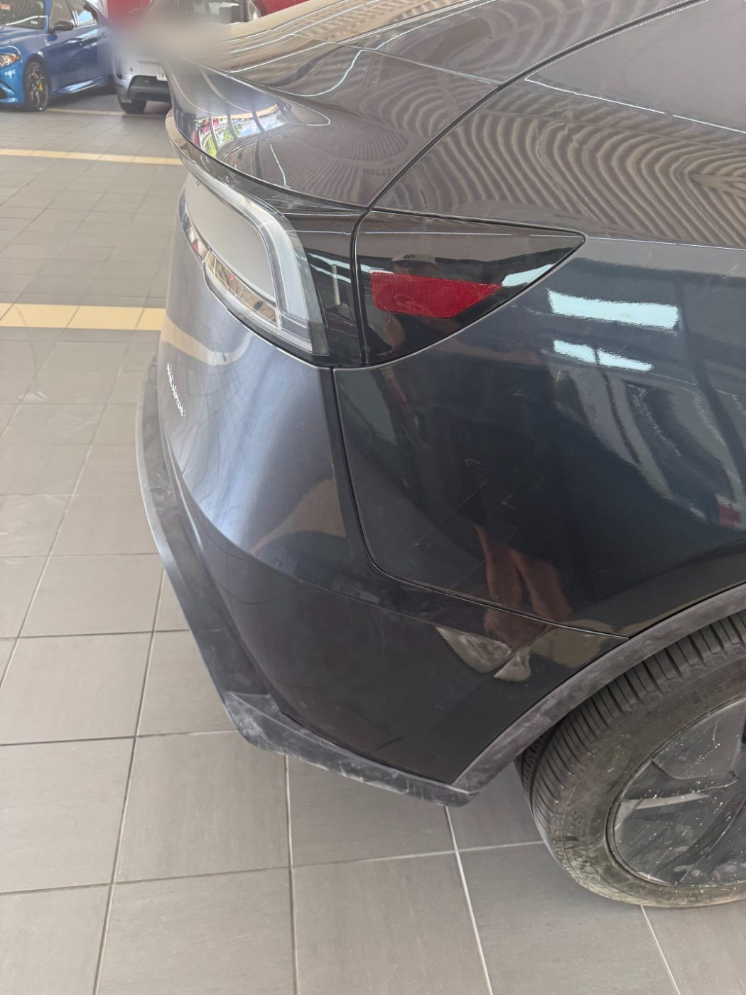 Tesla Model Y rear quarter repaired and refinished, wheel arch line restored